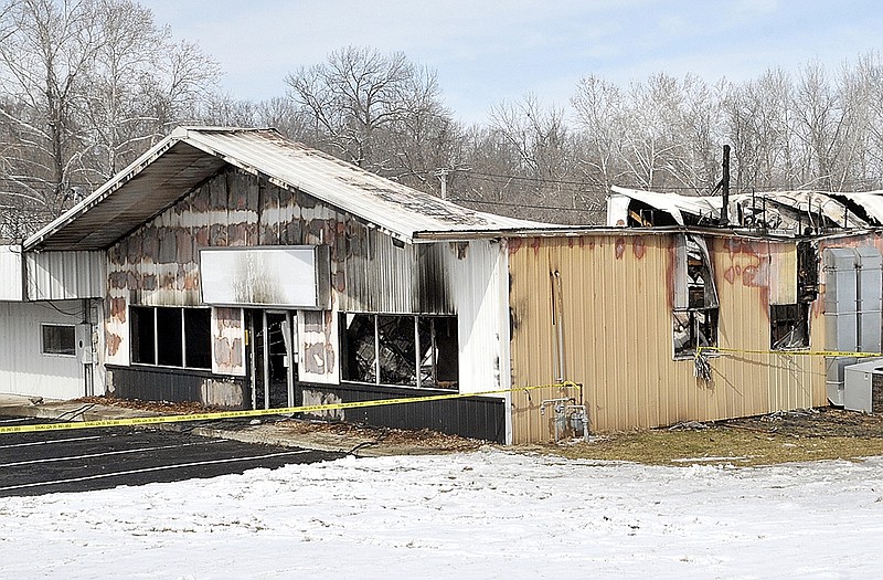 A gutted shell is all that remains the day after a fire at Cohen Used Autos on Old St. Louis Road.
