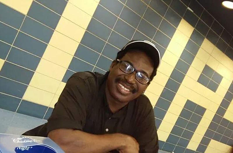 Johnny Evans Jr. is shown behind the cafeteria counter at Helias High School.