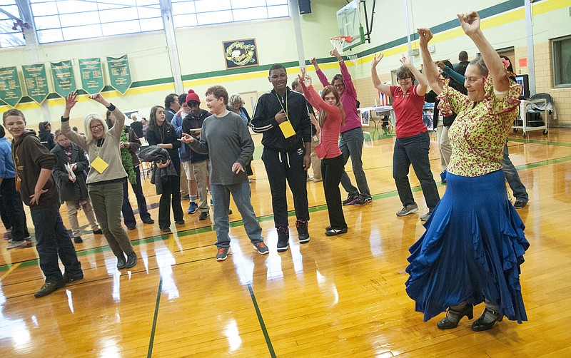 Marisel Salascruz, instructor with the St. Louis Cultural Flamenco Society, leads a group of students in a flamenco routine Tuesday inside the Missouri School for the Deaf (MSD) during its cultural fair, "Festival de Latinos."
