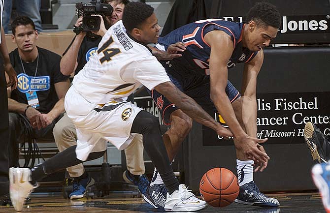 Auburn's TJ Lang, right, and Missouri's Keith Shamburger, left, vie for a loose ball during the first half of an NCAA college basketball game Tuesday, March 3, 2015, in Columbia, Mo.
