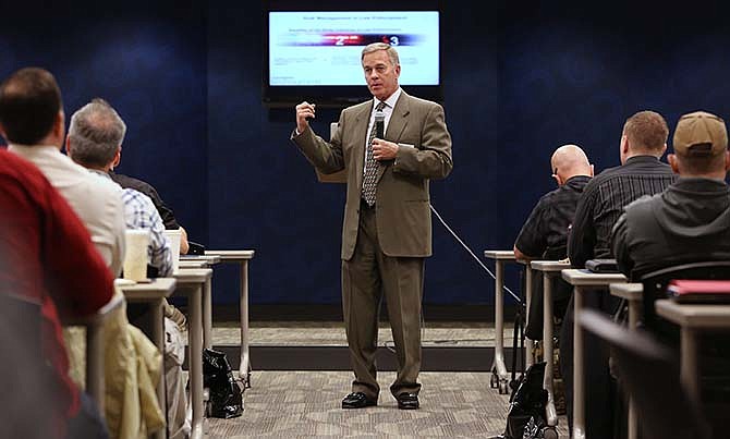 In this photo taken Thursday, Feb. 19, 2015, retired Cincinnati Police Chief Tom Streicher, discusses the benefits of body cameras during a conference hosted by Taser International at the California Highway Patrol headquarters in Sacramento, Calif. Taser, the stun-gun maker, has become a leading supplier of body cameras for police and has cultivated financial ties to police chiefs whose departments have bought the recording devices. A review by The Associated Press shows Taser is covering airfare and hotel stays for police chiefs who travel to speak at marketing conferences. It is also hiring some recently retired chiefs as consultants, sometimes months after their cities signed contracts with Taser.