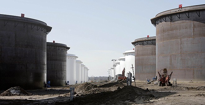 This March 2012 photo shows older and newly constructed 250,000-barrel capacity oil storage tanks at the SemCrude tank farm north of Cushing, Oklahoma. For the past seven weeks, the United States has been producing and importing an average of 1 million more barrels of oil every day than it is consuming. That extra crude is flowing into storage tanks, especially at the country's main trading hub in Cushing, pushing U.S. supplies to their highest point in at least 80 years, the Energy Department reported Wednesday, Feb. 25.