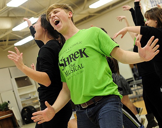 "Captain of the Guards" Jack Treu, center, and "Mama Bear" Mary Conley, left, sing together as they and the rest of the cast run through one of several musical numbers during a rehearsal for Helias Catholic's upcoming production of "Shrek the Musical."
