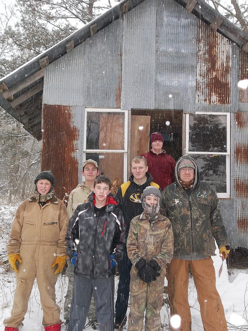 Boy Scout campers in front of the abandoned cabin they found to sleep in.