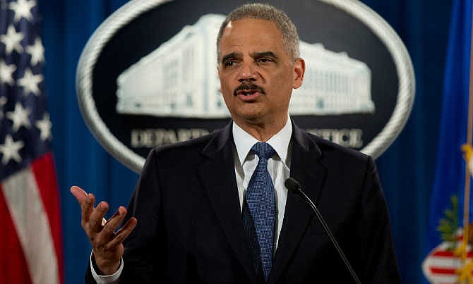 Attorney General Eric Holder speaks at the Justice Department in Washington, Wednesday, March 4, 2015, about the Justice Department's findings related to two investigations in Ferguson, Mo. The Justice Department will not prosecute a white former police officer in the fatal shooting of an unarmed black 18-year-old whose death in Ferguson sparked weeks of protests and ignited an intense national debate over how police treat African-Americans. But the government released a scathing report Wednesday that faulted the city for racial bias. 