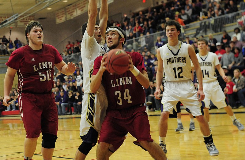 Linn's Blake Snyder looks to go up for a shot while being defended by Salisbury's Lane Springer during Wednesday's Class 2 sectional game at Fleming Fieldhouse.