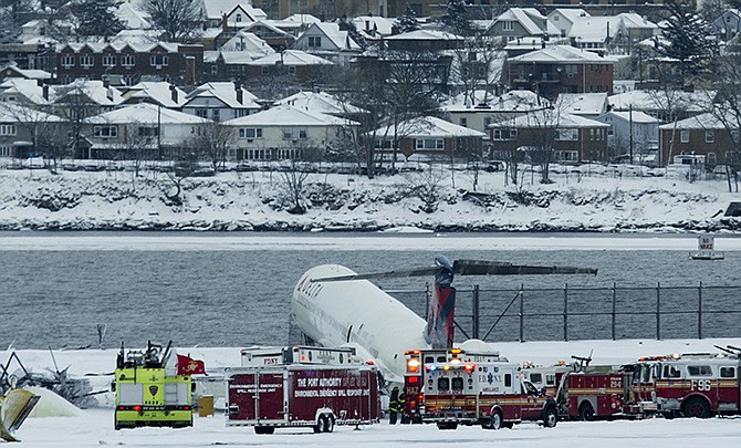 A Delta plane rests on a berm near the water at LaGuardia Airport in New York on Thursday. Delta Flight 1086, carrying 125 passengers and five crew members, veered off the runway at around 11:10 a.m., authorities said. Six people suffered non-life-threatening injuries, said Joe Pentangelo, a spokesman for the Port Authority of New York and New Jersey, which runs the airport.