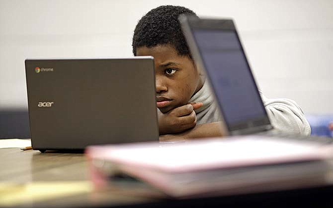 In this Feb. 12, 2015 photo, Marquez Allen, age 12, reads test questions on a laptop computer during in a trial run of a new state assessment test at Annapolis Middle School in Annapolis, Md. The new test, which is scheduled to go into use March 2, 2015, is linked to the Common Core standards, which Maryland adopted in 2010 under the federal No Child Left Behind law, and serves as criteria for students in math and reading. 