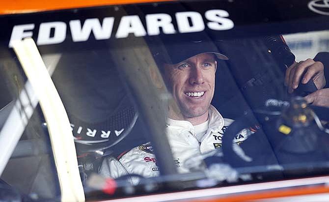 Driver Carl Edwards waits to leaves the garage to practice for Sunday's NASCAR Sprint Cup Series auto race, Saturday, Feb. 28, 2015, in Hampton, Ga.