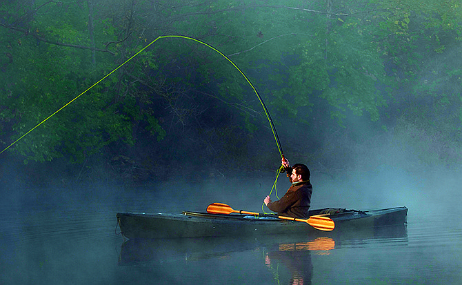 A kayak angler ties into a big fish on a Pyramid State Recreation Area strip pit.