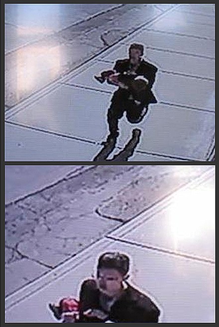 In this combination of still images taken from surveillance video on Sunday, a man runs down a street, carrying a toddler in an apparent kidnapping attempt in Sprague, Washington. The video shows the boy's young sister chasing after the man, who set the boy down and ran off. The boy, 22-month-old Owen Wright, was unhurt.