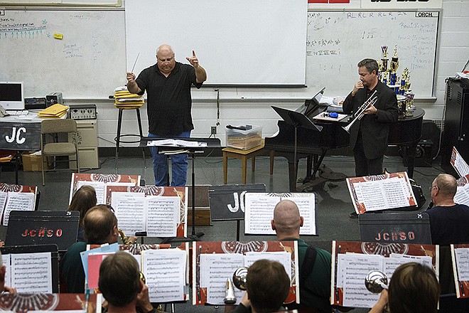 Truman State University professor Dr. Greg Jones, upper right , performs a trumpet solo with the JC Community Symphonic Band during their practice Tuesday evening.
