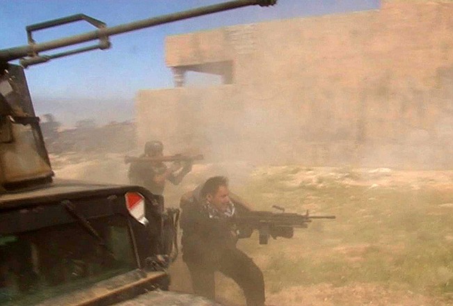 In this still image taken from video soldiers fire towards a target on Wednesday in Tikrit, Iraq. Iraqi soldiers and Shiite militiamen entered the Islamic State-held city on Wednesday, authorities said, breaching one of the biggest strongholds of the extremists in a key test for Iraqi forces.