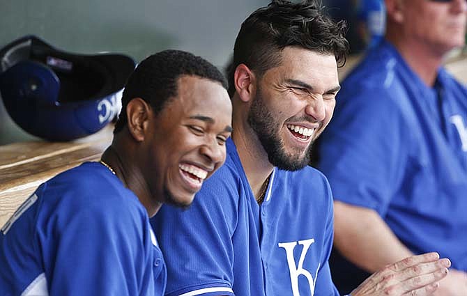 Kansas City Royals' Eric Hosner, right, has a good laugh with starting pitcher Yordano Ventura after Ventura finished three innings of scoreless pitching in a spring training baseball game against the San Diego Padres Wednesday, March 11, 2015, in Surprise, Ariz.