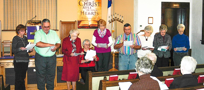 The Prayer of Praise at the California 2015 World Day of Prayer is given by members of Annunciation Catholic Church. Standing are participants Pat Roll, Charlie Roll, Joanne Colozza, Judy Scott, Russell Anderson, Helen Hainen, Jo Wolken and Joyce Ziehmer. Barb Walters, seated, introduced the speaking group.