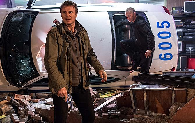 In this image released by Warner Bros. Pictures, Joel Kinnaman and Liam Neeson, left, appear in a scene from "Run All Night."