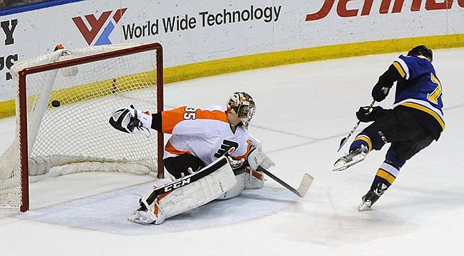 St. Louis Blues' T.J. Oshie, right, scores in a shootout against Philadelphia Flyers' goalie Steve Mason (35) during in an NHL hockey game, Thursday, March 12, 2015, in St. Louis.