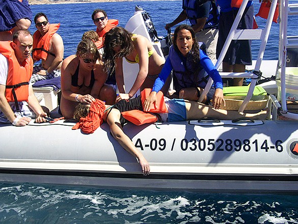 In this photo provided by the Procuraduria Federal de Proteccion al Ambiente (PROFEPA), shows a woman receiving CPR aboard a small boat after she was injured by a breaching grey whale that hit the boat on Thursday, near the beach resort of Cabo San Lucas, Mexico. Mexican authorities said that a 35-year-old Canadian woman has died and two other tourists were injured near the beach resort when a surfacing grey whale crashed onto their boat as they came back from a snorkel tour.