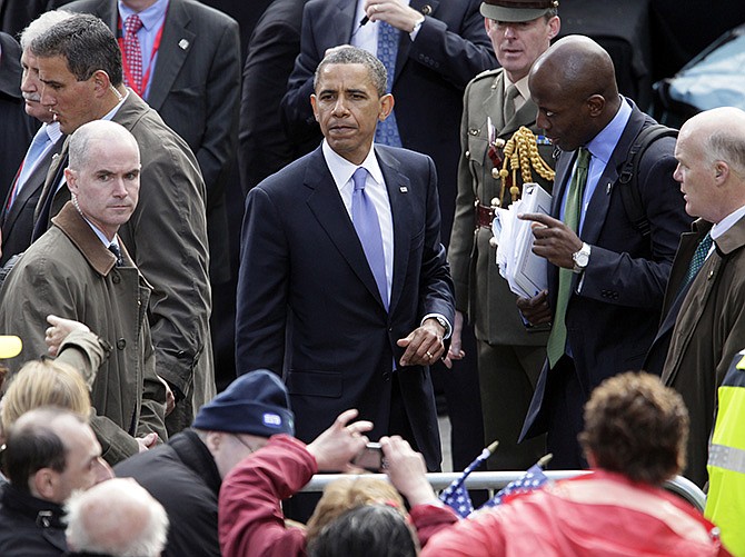 President Barack Obama pauses in 2011 as he shakes hands with people in the crowd after speaking at College Green in Dublin, Ireland. Mark Connolly, the second-in-command on President Barack Obama's security detail is pictured far left, along with recently appointed Secret Service Director Joseph Clancy, far right, and Reggie Love, Obama's former personal aide at the White House. 