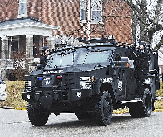 Jefferson City's SWAT Team pulls away from a residence Friday at Center and East High Street.