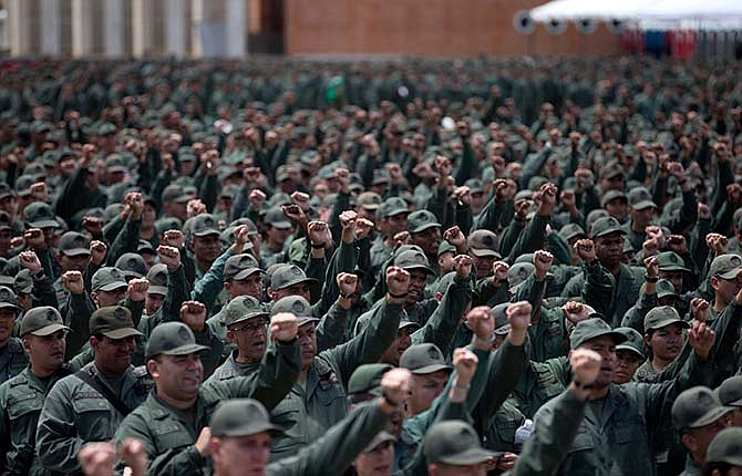 Venezuelan army reserve members cheer prior to the start of civilian and military exercises at fort Tiuna in Caracas, Venezuela, Saturday, March 14, 2015. Venezuelan President Nicolas Maduro is expected to oversee military exercises across the country, which are intended to show the South American country's strength in the face of U.S. threats. 