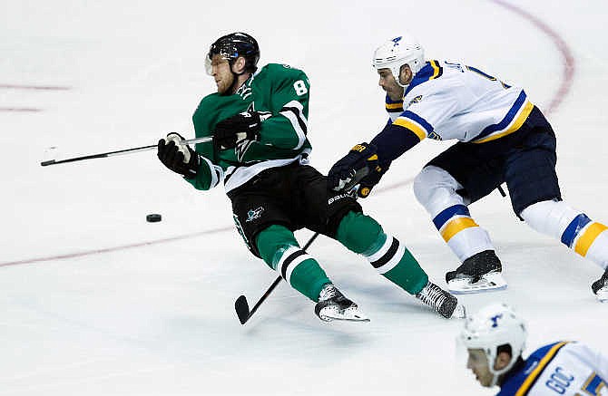 St. Louis Blues defenseman Barret Jackman (5) trips Dallas Stars right wing Ales Hemsky (83) in the first period of an NHL hockey game, Sunday, March 15, 2015, in Dallas. Jackman was penalized on the play.