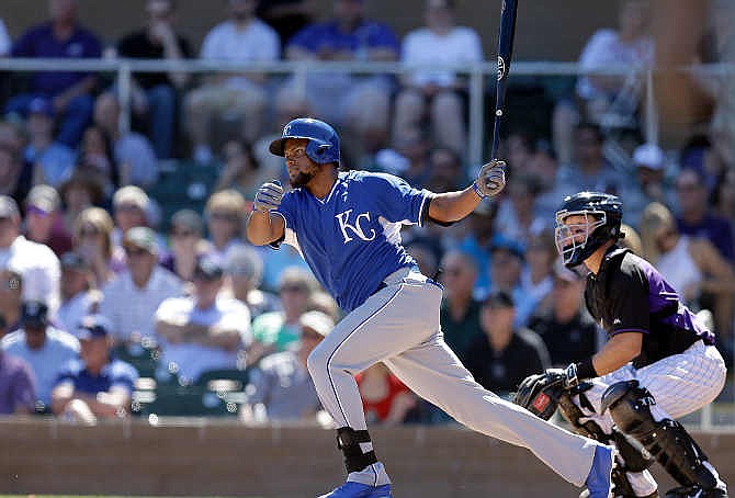 Kansas City Royals' Jorge Bonifacio follows through on a single hit off Colorado Rockies' Kyle Kendrick in the second inning of a spring training exhibition baseball game, Sunday, March 15, 2015, in Scottsdale, Ariz. 