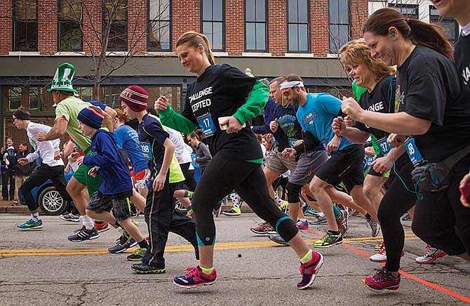 Participants in the YMCA's Luck of the Irish 5K Run/Walk leave the starting line at the intersection of Jefferson and High Streets in Jefferson City on Saturday morning. 
