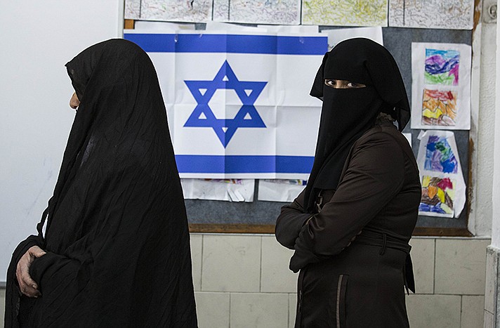 Bedouin women wait to cast their votes at a polling station in the Israeli town of Rahat.