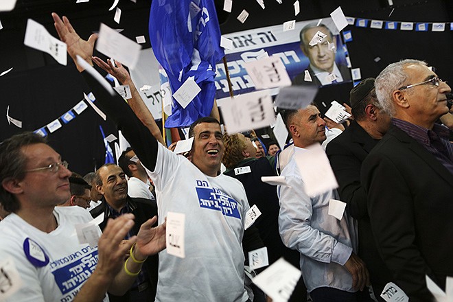 Israeli Prime Minister Benjamin Netanyahu Likud party supporters react to exit poll results Tuesday at the party's election headquarters In Tel Aviv. Israelis are voting in early parliament elections following a campaign focused on economic issues such as the high cost of living, rather than fears of a nuclear Iran or the Israeli-Arab conflict.