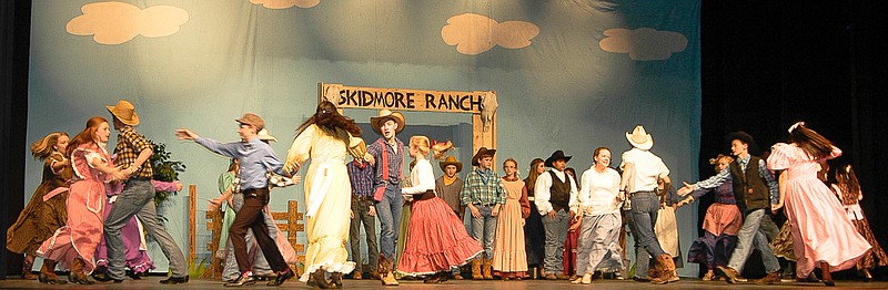 The cowboys and the farmers dance after singing "The Farmer and the Cowman" in the musical production "Oklahoma!"
