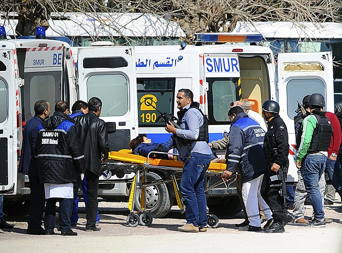 A victim is evacuated by rescue workers outside the Bardo Museum Wednesday in Tunis, Tunisia. Gunmen opened fire at a leading museum in Tunisia's capital, killing 19 people and wounding at least 44, including foreign tourists, authorities said. A later raid by security forces left two gunmen and one security officer dead but ended the standoff, Tunisian authorities said.