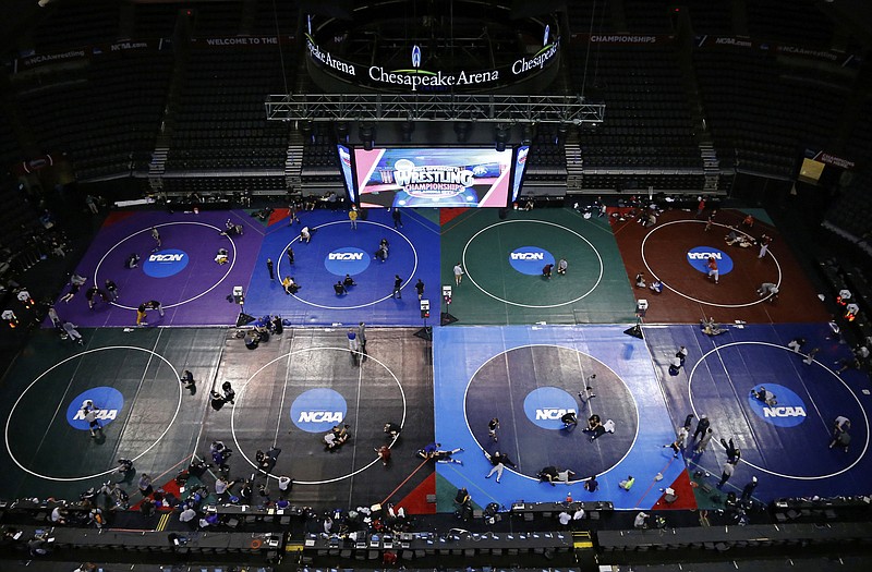 Wrestlers prepare for the 2014 NCAA wrestling championships last March in Oklahoma City.  The 2015 championships begin today in St. Louis. 