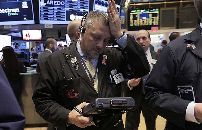 Trader Jason Harper works on the floor of the New York Stock Exchange, Thursday, March 19, 2015. Stocks are edging lower in early trading, giving up some of the gains they made the day before.