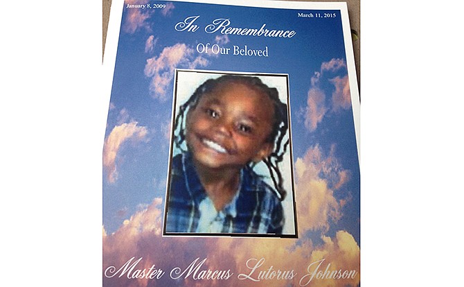 This image provided by Marcus Johnson Sr. shows Marcus Johnson Jr.'s funeral pamphlet. Marcus Johnson Jr.'s parents figured a sunny day at a city park was just what the 6-year-old kindergartner needed while recovering from heart surgery the previous week and a doctor's visit that same day. Instead, his family will bury Marcus on Thursday, March 19, 2015, after the child was shot in the chest and killed in an attack his mother and father said stemmed from a traffic dispute. 