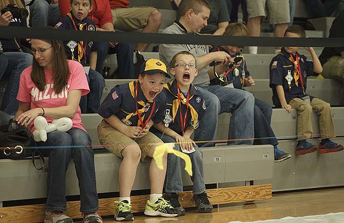 Mason Wall, left, and Anthony Hays, both of Pack 9, cheer on their cars during the Five Rivers District Pinewood Derby Saturday at Blair Oaks Middle School.