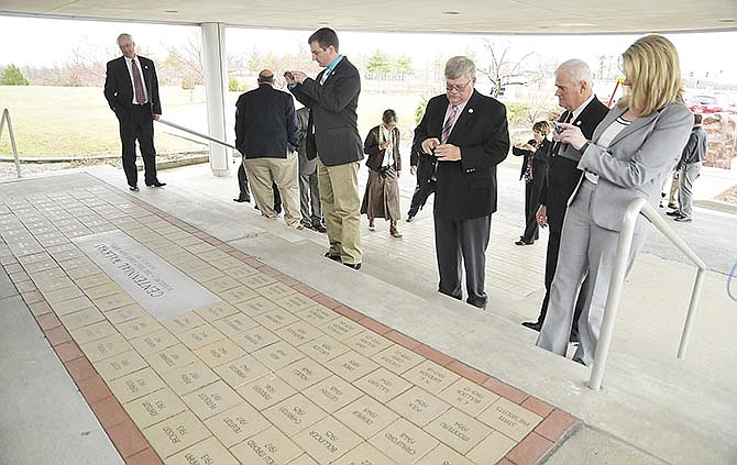 Members of the Missouri Farm Bureau Board of Directors take pictures of the new Centennial Walkway after its was unveiled following a luncheon celebration in Jefferson City. 