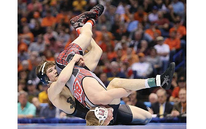 Missouri's Drake Houdashelt (left) wrestles Edinboro's David Habat for the 149-pound title Saturday in the NCAA Championships in St. Louis.