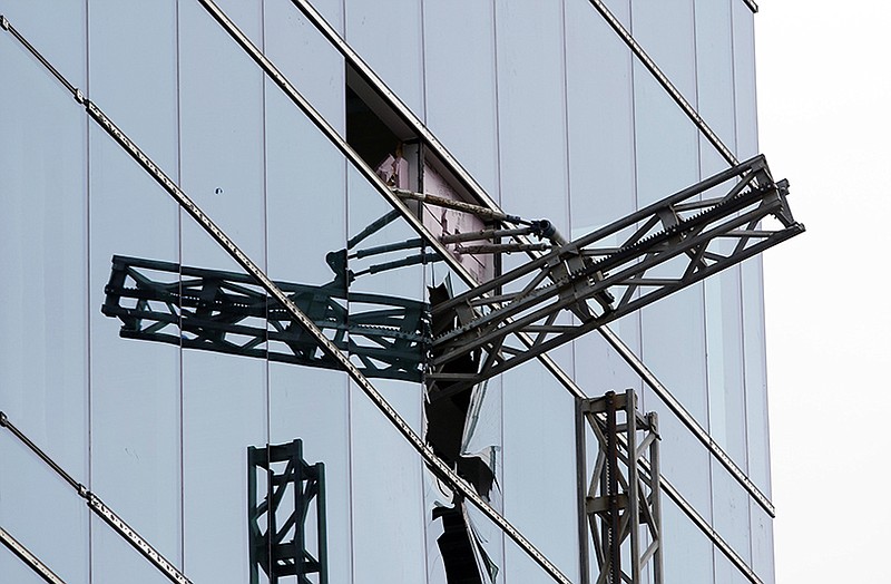 A section of scaffolding protrudes from a shattered window at the scene of a construction accident that killed three people and sent another to a hospital Monday in Raleigh, N.C. 