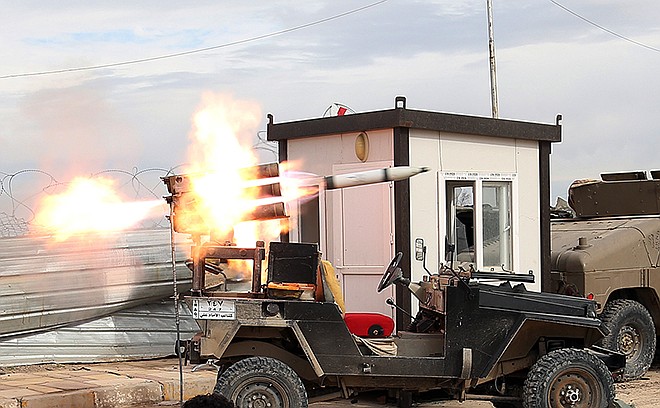 Members of an Iraqi Shiite militant group called Imam Ali Brigades launch rockets against Islamic State extremist positions Tuesday during clashes in Tikrit, 80 miles north of Baghdad, Iraq.