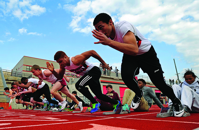 Runners fire out of the blocks at the start of the second heat in the boys 100-meter dash in Tuesday's dual meet between Jefferson City and Helias at Adkins Stadium.