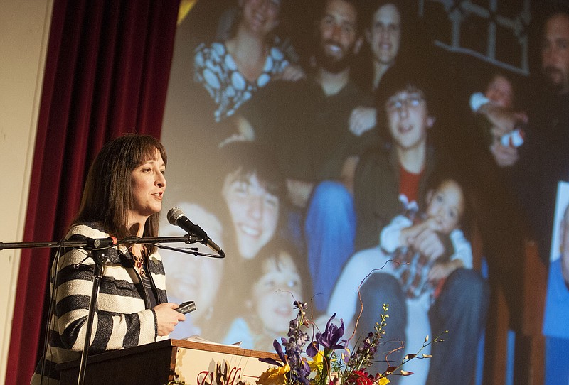 Jane McClellan, the 2015 Kingdom of Callaway Supper guest of honor, speaks to an audience of more than 260 Tuesday night inside Dulany Auditorium. McClellan spoke about her love of family (some members are pictured on the projection screen) and how Callaway County values carried throughout her life.