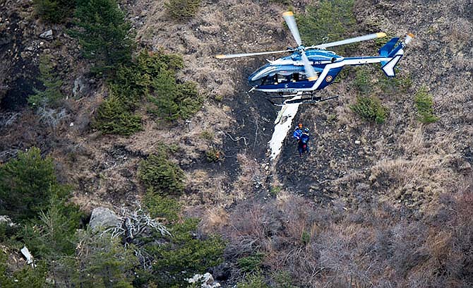 This photo provided by the Gendarmerie Nationale shows rescue workers being rappelled from an helicopter on the crash site near Seyne-les-Alpes, French Alps, Wednesday, March 25, 2015. French investigators cracked open the badly damaged black box of the Germanwings plane on Wednesday and sealed off the rugged Alpine crash site where 150 people died when their plane on a flight from Barcelona, Spain to Duesseldorf, Germany, slammed into a mountain Tuesday.