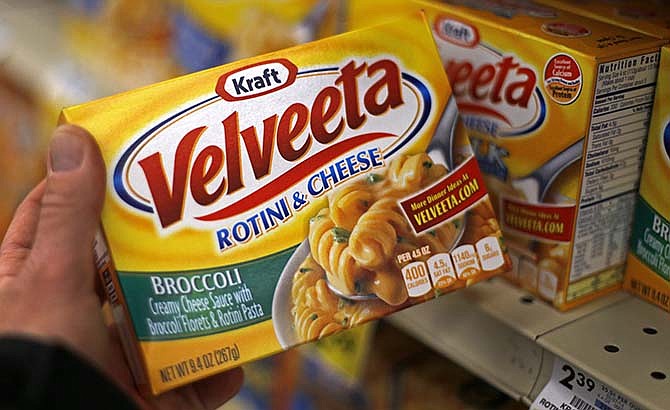 This Tuesday, April 29, 2014 photo shows a display of Kraft Velveeta rotini and cheese at a grocery market in Pittsburgh. Heinz Co. is buying Kraft Foods Group Inc., creating what the companies say will be the third-largest food and beverage company in North America, the companies announced Wednesday, March 25, 2015. 