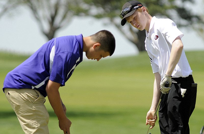 Kent Uhlmann of Jefferson City (right) waits to putt during action last season. Uhlmann and the Jays are scheduled to start the golf season today at Wayensville.