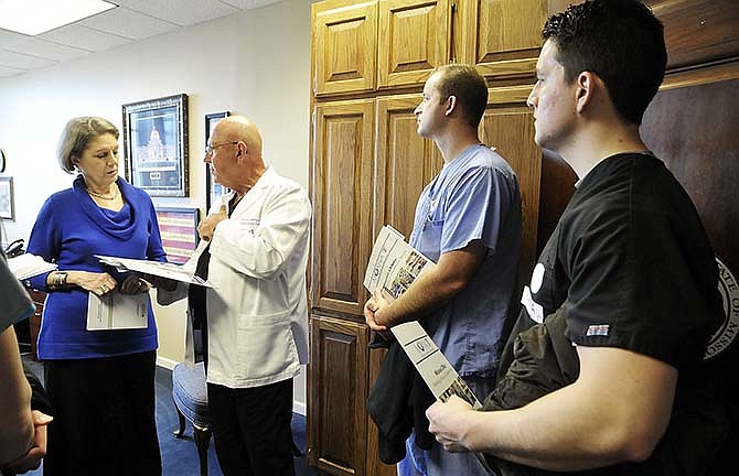 In this Feb. 25, 2015, photo, several Certified Registered Nurse Anesthetists scattered throughout the Missouri Capitol to visit with legislators or their staffs to ask them to oppose two particular bills. Here, from right, Casey Brooks and Tony Sanders, both CRNA's from St. Louis, listen as Ron Lenninger, a nurse anesthetist at Capital Region Hospital, talks to Carolyn Loethen, legislative assistant to Sen. Mike Kehoe, R, Jefferson City. Also in the group were Kristen Richter, Columbia (formerly from Jefferson City) and Jessica Premis of St. Louis.
