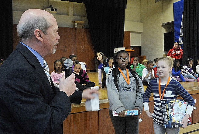 Councilman Rick Mihalevich informs Jerica Austin, middle, and Lydia Craig, that they are invited to read their winning essays before the public during a Jefferson City council meeting in April. South School hosted an assembly Friday during which 10 fifth-grade students were recognized for their essays about being the mayor of Jefferson City.