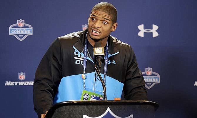 In this Feb. 22, 2014, file photo, Missouri defensive end Michael Sam speaks during a news conference at the NFL football scouting combine in Indianapolis. Michael Sam says there are "a lot" of gay players in the NFL and some have reached out to him. The Fort Worth Star-Telegram reported Sam gave a speech Thursday, at the Dallas Holocaust Museum and took questions from the audience.Sam said: "I'm just saying there is a lot of us." He added he'd never out a player who confided in him, but "there's some famous people."