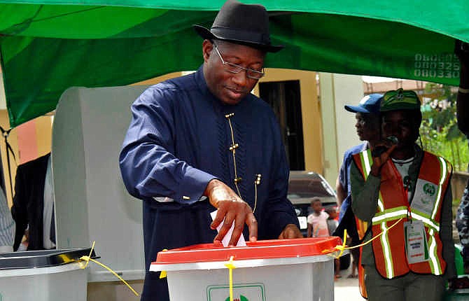 In this photo provided by the Nigerian State House, Nigerian President Goodluck Jonathan casts his ballot, in Otuoke, Nigeria, Saturday, March 28, 2015. Nigeria has extended voting to Sunday after problems occurred as millions turned out Saturday to vote in a presidential election that analysts say is too close to call between President Goodluck Jonathan and former military dictator Muhammadu Buhari. 