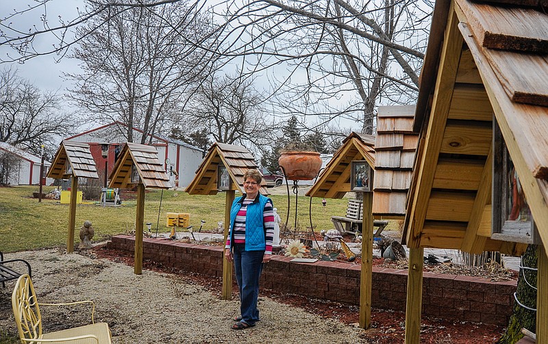 Lorraine Smith prays daily guided by the 14 Stations of the Cross installed in her backyard garden this winter.